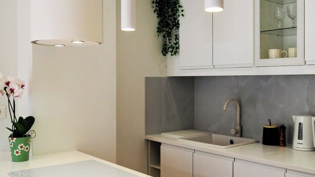 A modern kitchen with white cabinetry, a built-in sink, and pendant lighting. - Athens White House 🏠  (Athina)