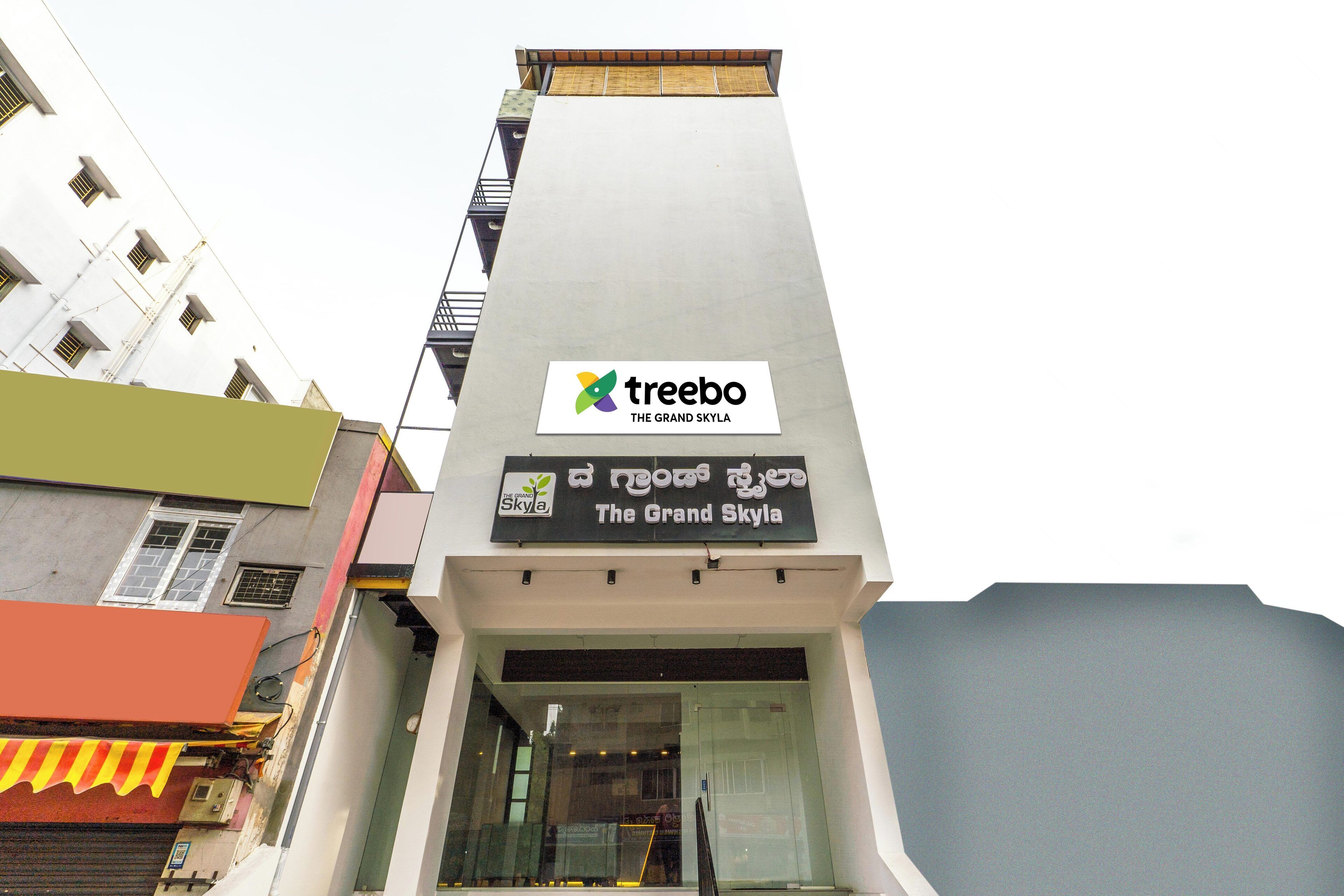 A building with a sign for 'Treebo The Grand Skylia'.