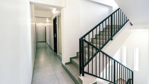 A modern interior with a staircase and a hallway. - Treebo The Grand Skyla, Malleshwaram (Bengaluru)