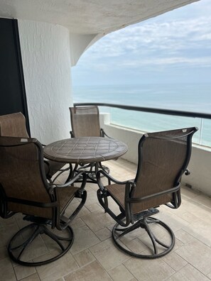Enjoy a meal or a moment of relaxation on this balcony with a round table and four chairs.