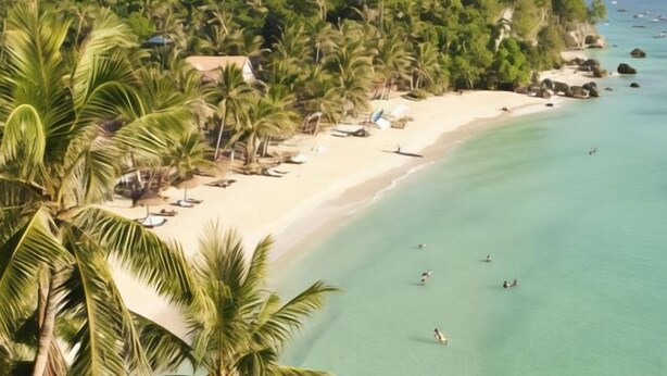 A beach with clear turquoise water, palm trees, and a few people swimming. - Sea Wind Resort (Boracay Island)