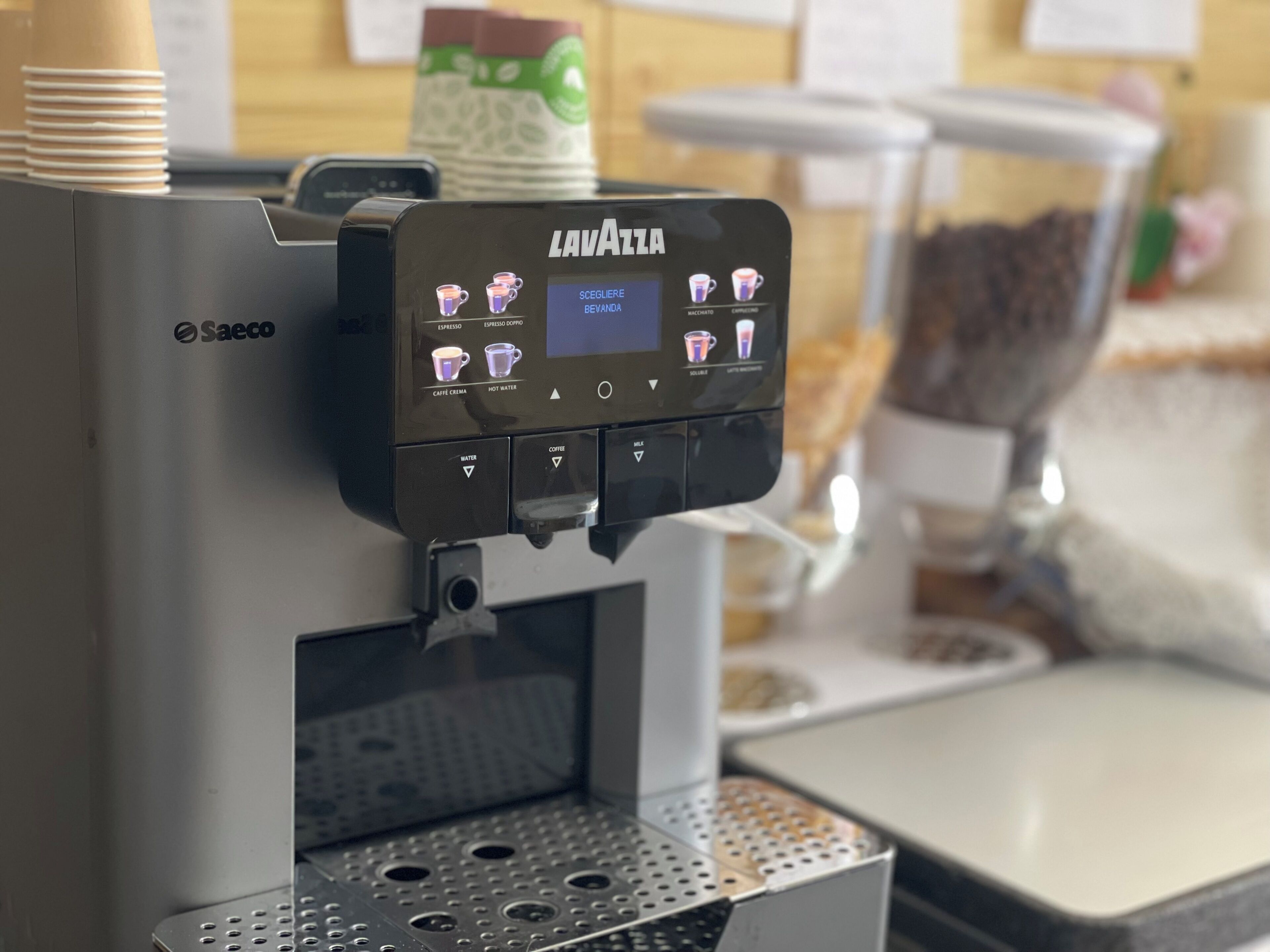 A coffee machine with a digital interface for selecting beverages.