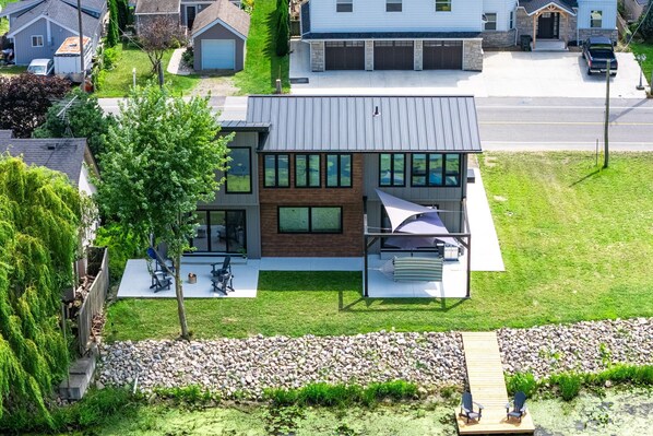 A modern two-story house with a patio, a small deck, and a stone pathway. - Wild Goose Landing- Located near local wineries and breweries (Kingsville)