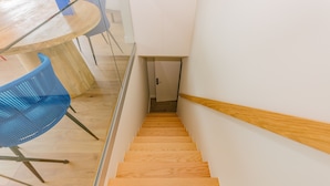 A staircase with wooden steps leading to a door at the top.