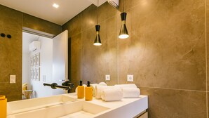 A modern bathroom with a large mirror, dual sinks, and a towel rack. - NEW! ESTORIL SEAFRONT 1BEDROOM APARTMENT (Estoril)