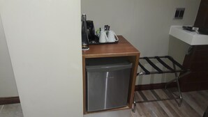 A compact kitchenette with a stainless steel refrigerator, a coffee maker, and a sink. - Potchefstroom Guest House with WiFi (Potchefstroom)