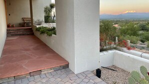 A covered outdoor area with terracotta flooring, a wooden ceiling, and a view of a landscape with mountains and vegetation. - 100 mile views! 6000 sq ft 4-bedroom house, salt pool in fabulous Fountain Hills (Fountain Hills)