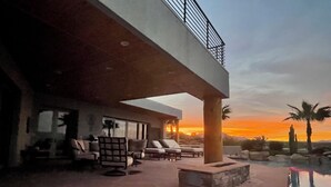 A modern outdoor lounge area with stone flooring, lounge chairs, and a pool. - 100 mile views! 6000 sq ft 4-bedroom house, salt pool in fabulous Fountain Hills (Fountain Hills)