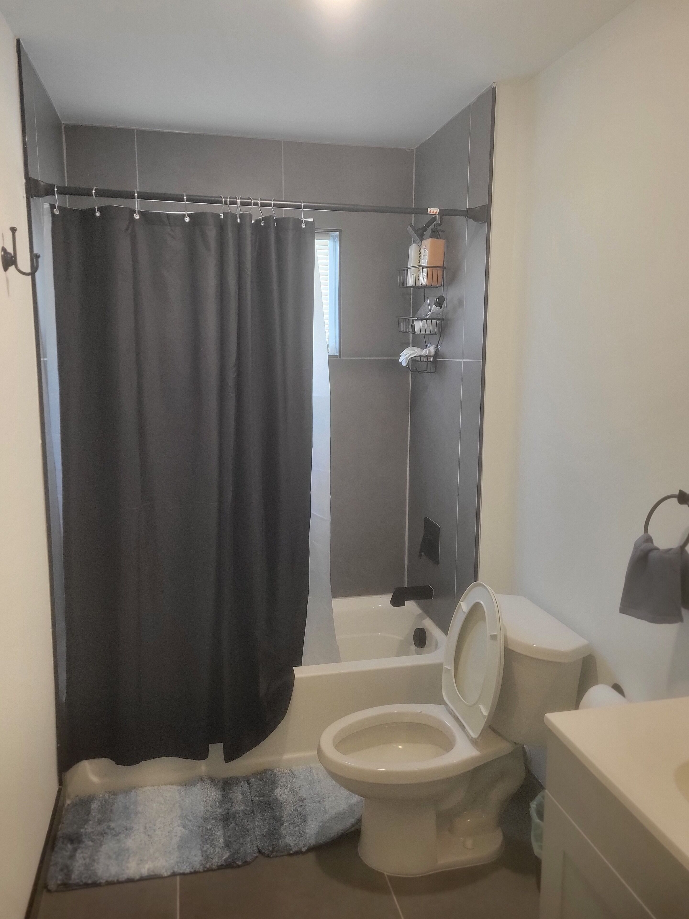 A bathroom with a bathtub, toilet, and sink.