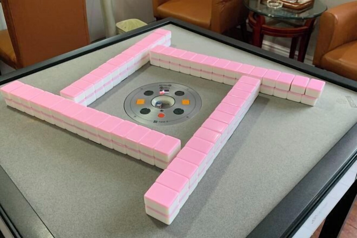 A table with a Mahjong game set up on it.