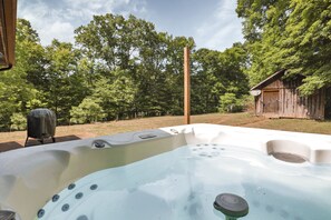 A hot tub with a wooden structure in the background.