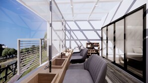 Un espacio habitable moderno y de planta abierta, con techo de vidrio, muebles de madera y vistas al exterior.
