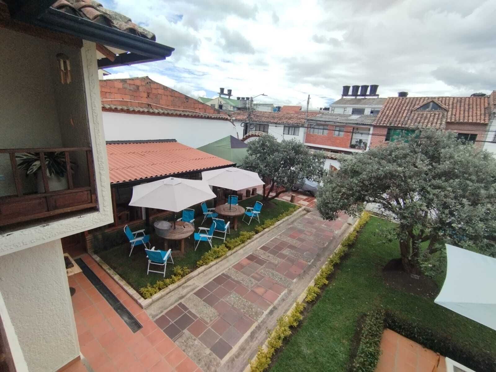 A courtyard with outdoor seating, a tiled patio, and surrounding buildings.
