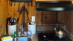 A kitchen with wooden cabinets, a sink, a stove, and various kitchen utensils and appliances. - Secluded Nature Escape, Pet Friendly with WiFi in Three Rivers (Three Rivers)