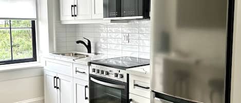 Fridge, microwave, coffee/tea maker, cookware/dishes/utensils