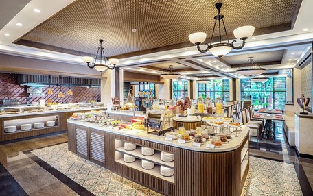 A modern breakfast bar with a variety of food items and a seating area with tables and chairs.