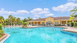 A large outdoor swimming pool with a building in the background.