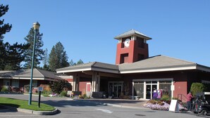 A building with a clock tower, a covered entrance, and a sign that reads "DO NOT ENTER." - Impressive Deck - 301B (Kelowna)