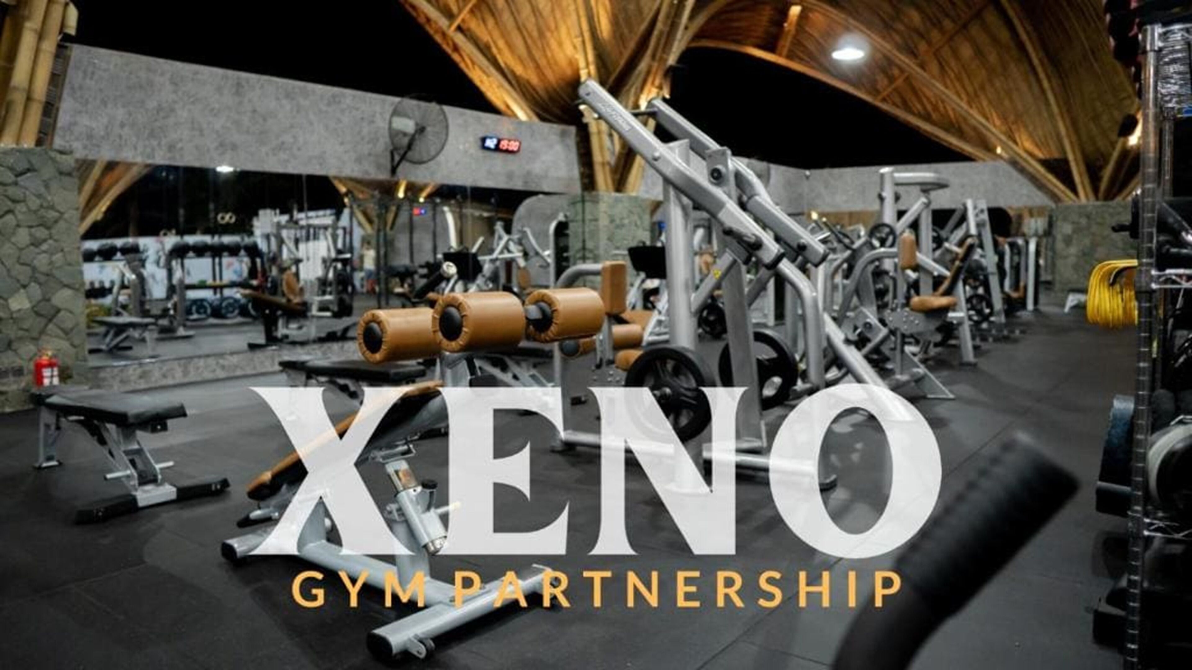 A gym with various exercise equipment, including weight machines and benches.