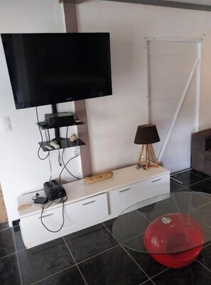 Relax in this stylish living space with a flat-screen TV and comfortable seating area.