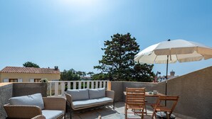 A rooftop patio with a sofa, chairs, and an umbrella. - Pine's Mansion by Interhome (Le Barcarès)