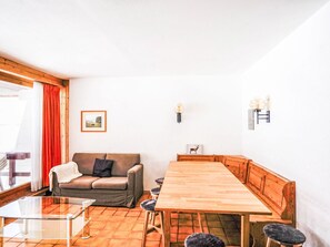 Cozy living space with a dining table, sofa, and coffee table, perfect for relaxing.