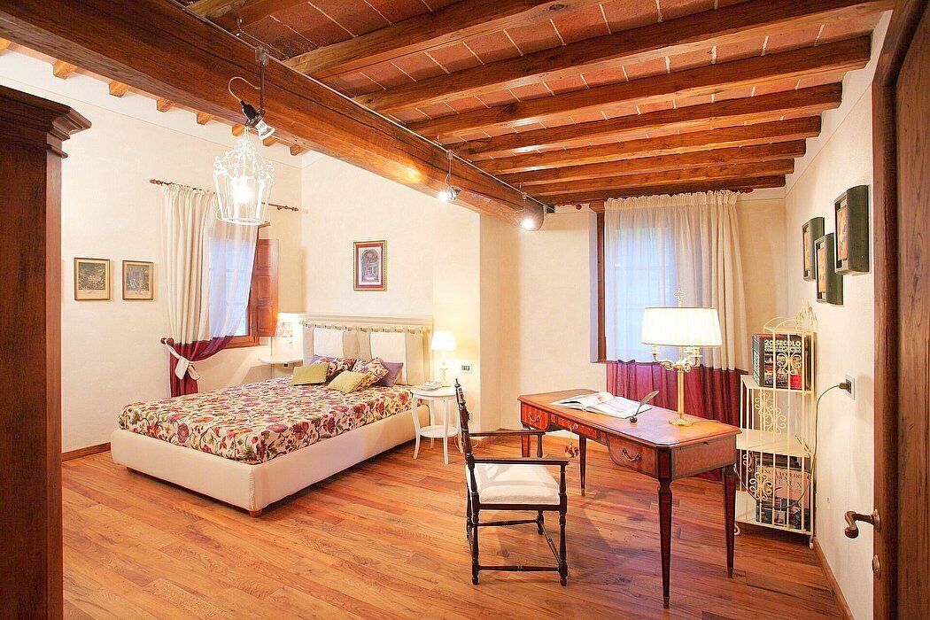 A bedroom with a bed, a desk, a chair, and a bookshelf.