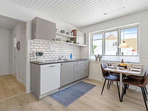 Enjoy meals in this kitchen with a dishwasher and sink, and take in the view from the window.