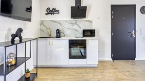 Een koffiezetapparaat/waterkoker, een koelkast, een magnetron, een oven