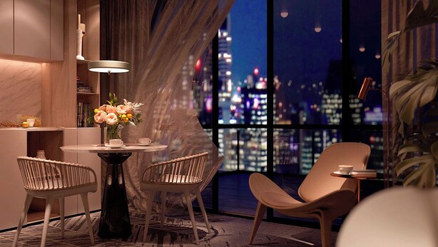 A modern hotel room with a city view, a round table, two chairs, a vase with flowers, and a bookshelf. - Gajrash Suites (Baku)