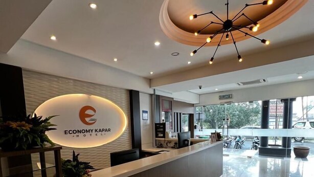 A modern hotel reception area with a prominent sign for 'Economy Kapar Hotel'. - HOTEL ECONOMY KAPAR (Kapar)