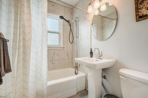 A bathroom with a bathtub, a sink, a toilet, and a shower. - The Foote Hills (Colorado Springs)