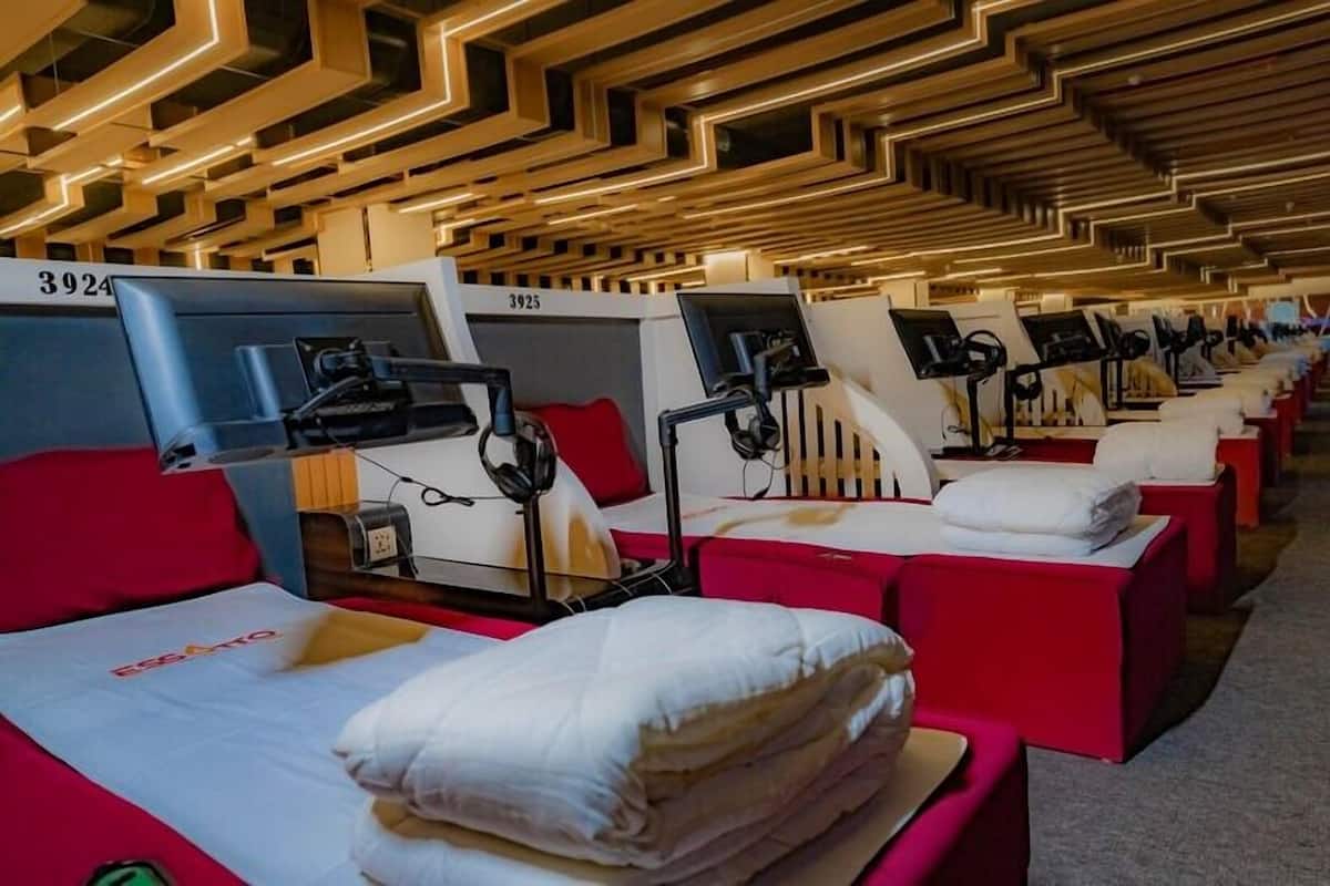 A row of beds with individual headrests and attached monitors, each labeled with a number.
