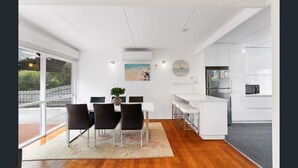 A modern kitchen with white cabinets, a stainless steel refrigerator, and a microwave. - Perfect location,  5 min walk to the beach, shops. Supermarkets and cafes.  (Cowes)