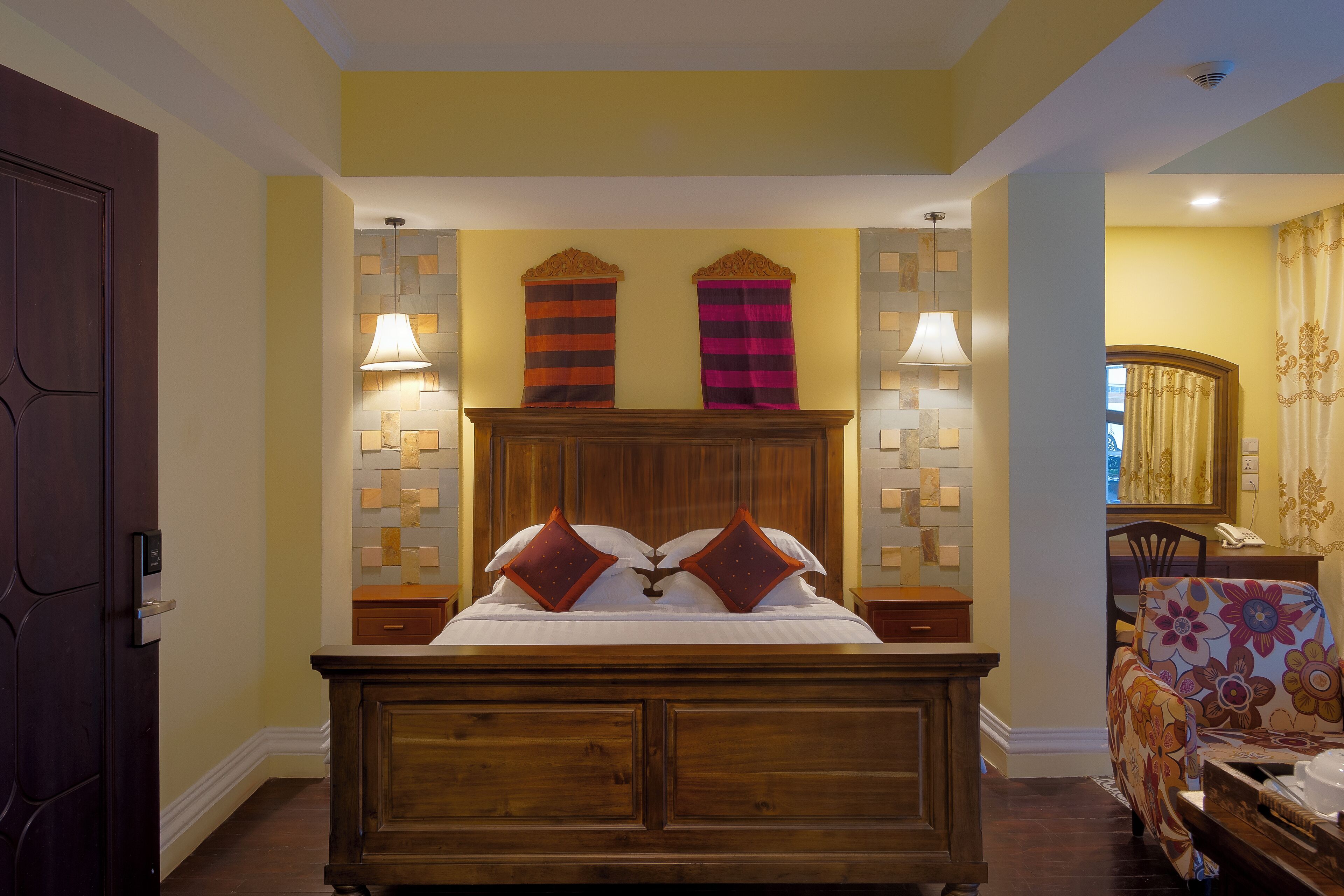 A bedroom with a wooden bed, two bedside lamps, and a decorative wall panel.