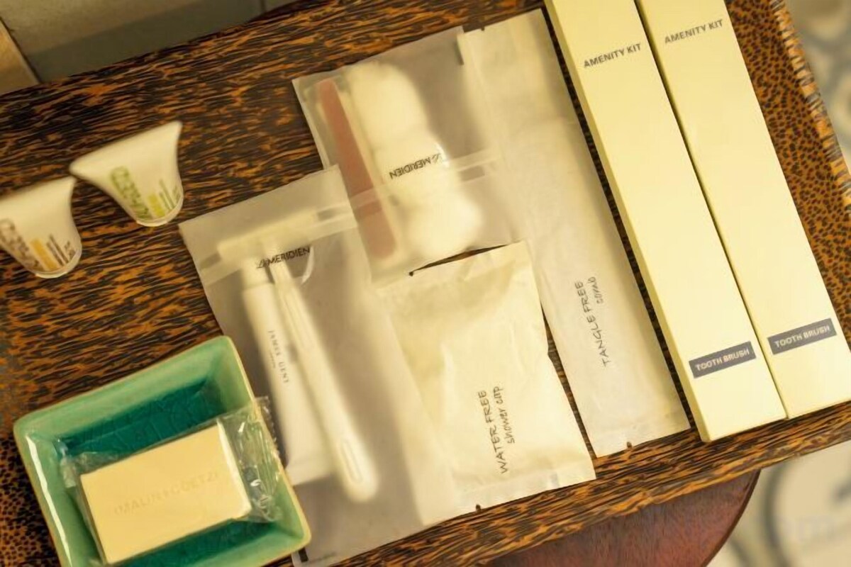 A tray with toiletries including a toothbrush, toothpaste, and a bar of soap.