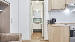 A modern kitchen with wooden cabinets, a countertop, and a built-in oven.