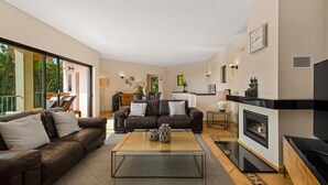 A modern living room with a sofa, a coffee table, and a fireplace. - Luxury 4 bed Villa with private pool Bendinat (Palma de Mallorca)