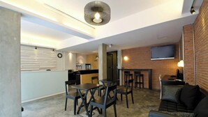 A modern interior with a dining area, kitchen, and seating space.