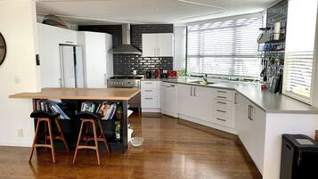 Fridge, stovetop, dishwasher, coffee/tea maker