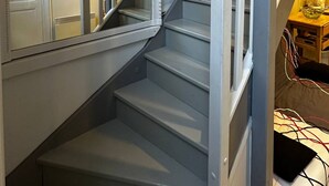 A staircase with a white railing and a decorative balustrade.