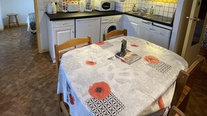 A compact kitchen with white cabinets, a microwave, a toaster, and a sink.