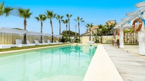 A swimming pool with lounge chairs and a wooden deck. - Armon a D nia in Val Ncia (Denia)