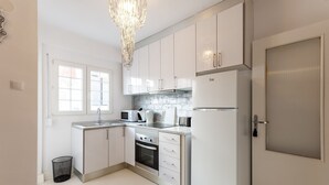 A modern kitchen with white cabinets, stainless steel appliances, a built-in oven, and a microwave. - Samba in Gandia With 3 Bedrooms and 1 Bathrooms (Gandia)