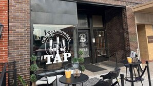 A building with a large glass window displaying the logo "Central Normal TAP". - Little Red Loft | Cozy Guest Suite Apartment (Danville)