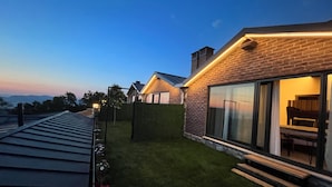 A modern house with a brick exterior, large windows, and a well-maintained lawn. - MASKLAVİ (Kestel)
