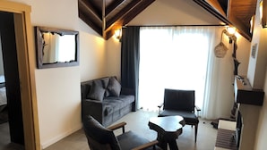 A modern living room with a sofa, two armchairs, a coffee table, and a fireplace. - MASKLAVİ (Kestel)