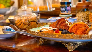 A breakfast buffet with various pastries, fruits, and a coffee station. - La Casa Di Agartha (Bolsena)
