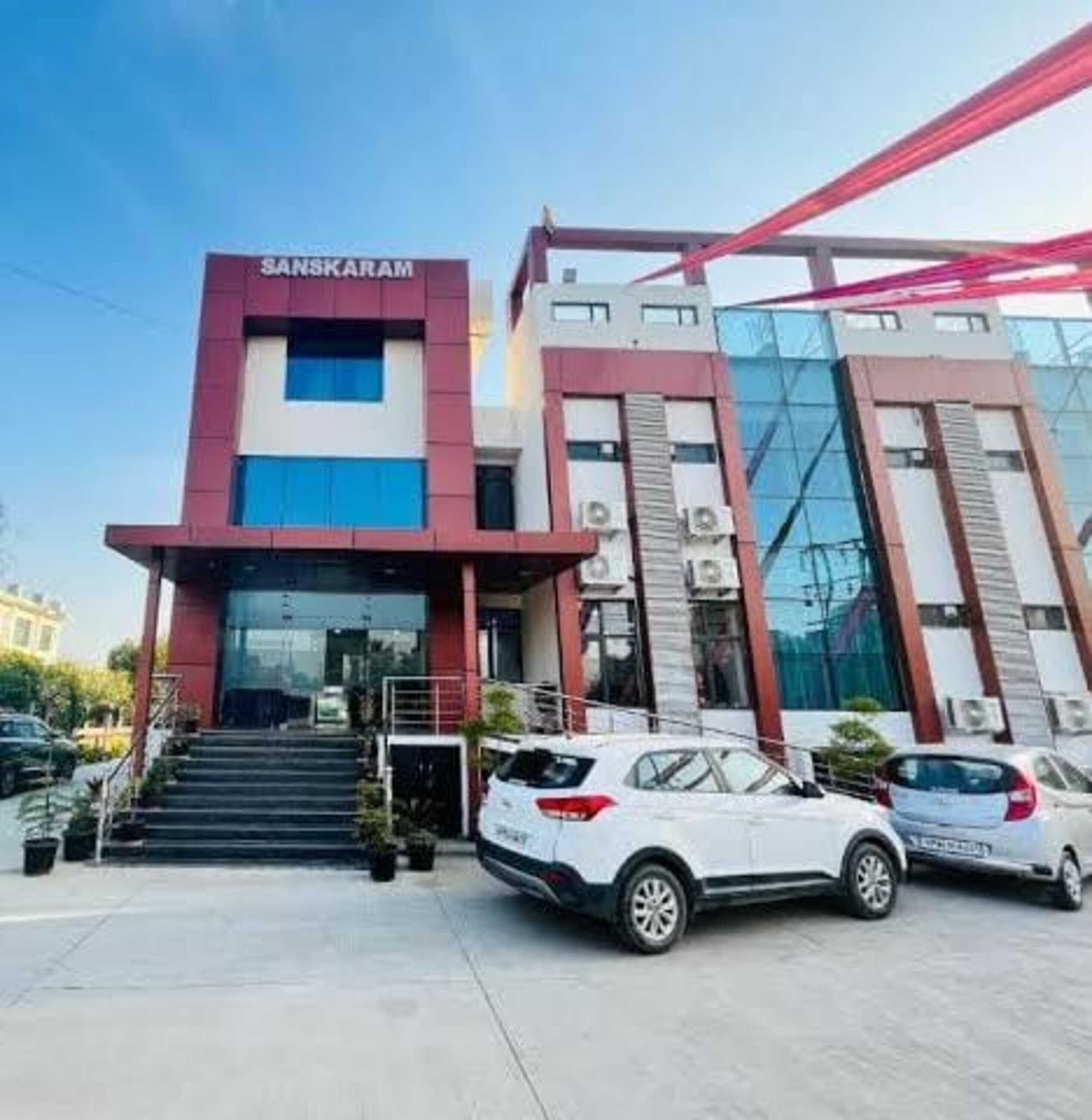 A modern building with a sign reading "SANSKARAM" at the entrance.