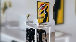 A modern office space with a desk, laptop, and a coffee cup.